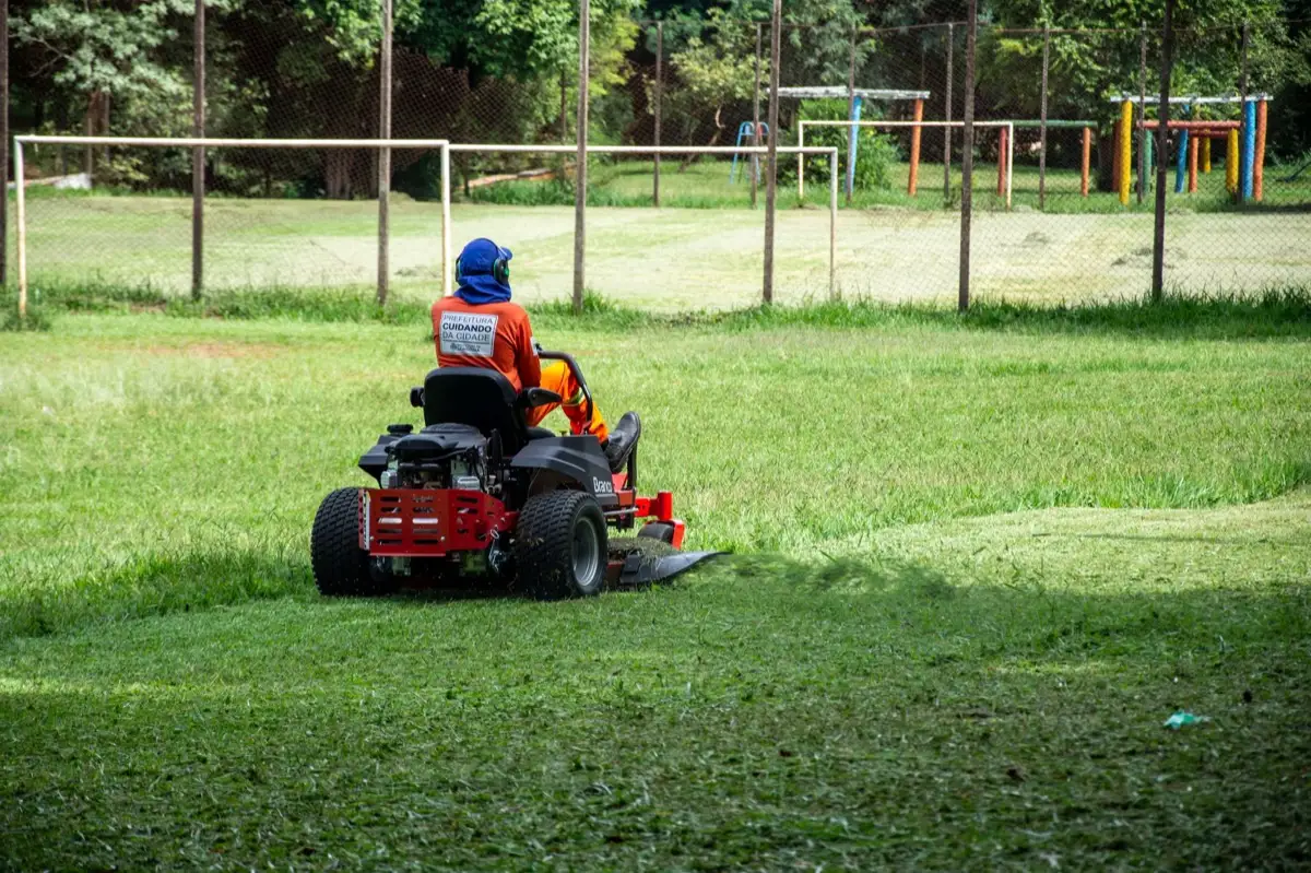 A commercial mower cutting a large area of grass